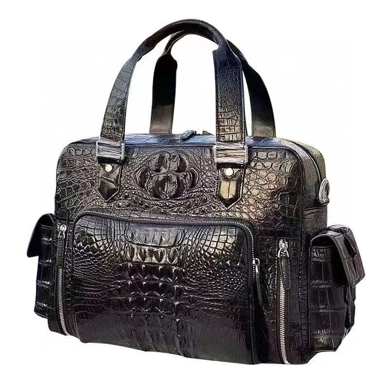A black crocodile-embossed leather duffel bag with dual top handles, multiple zippered pockets, and a decorative embossed emblem on the front, shown against a plain white background.