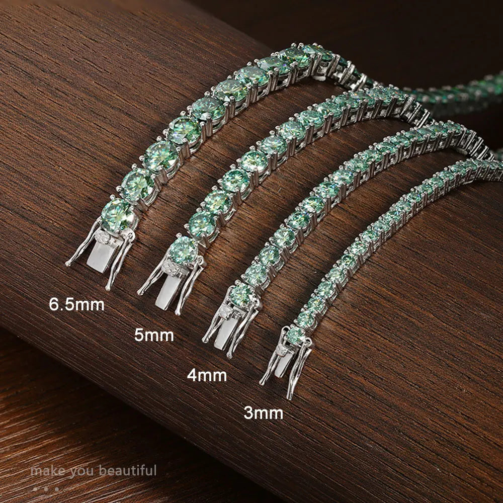 Set of green gemstone bracelets with size measurements on a wooden surface