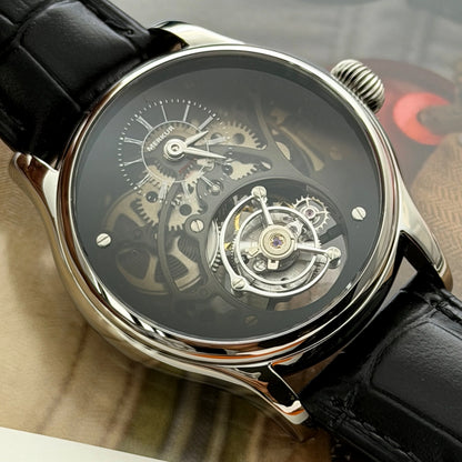 Close-up of a mechanical watch with a black strap on a blurred background