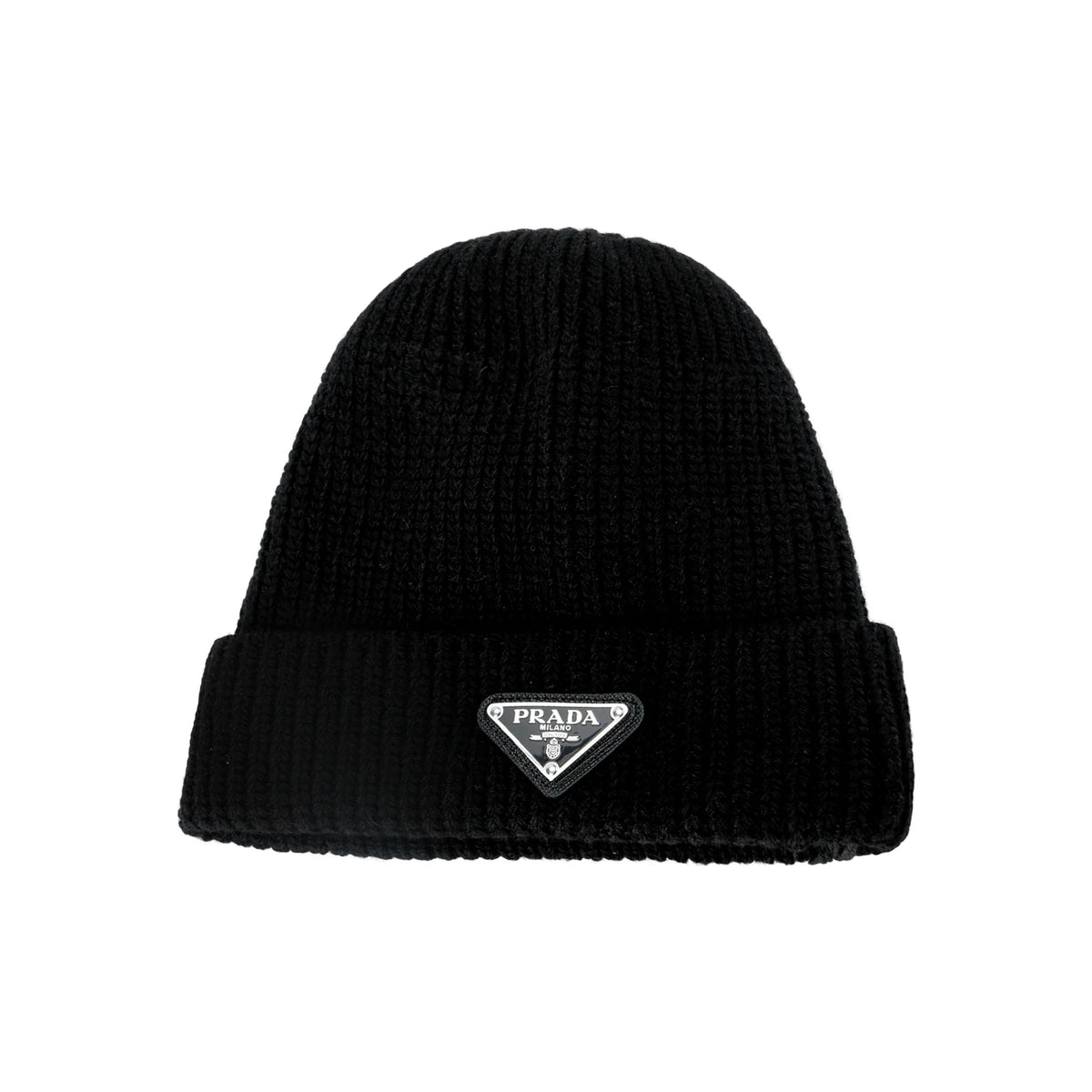 A black ribbed knit beanie hat featuring a small silver-tone triangular Prada logo patch on the front folded cuff, set against a plain white background.