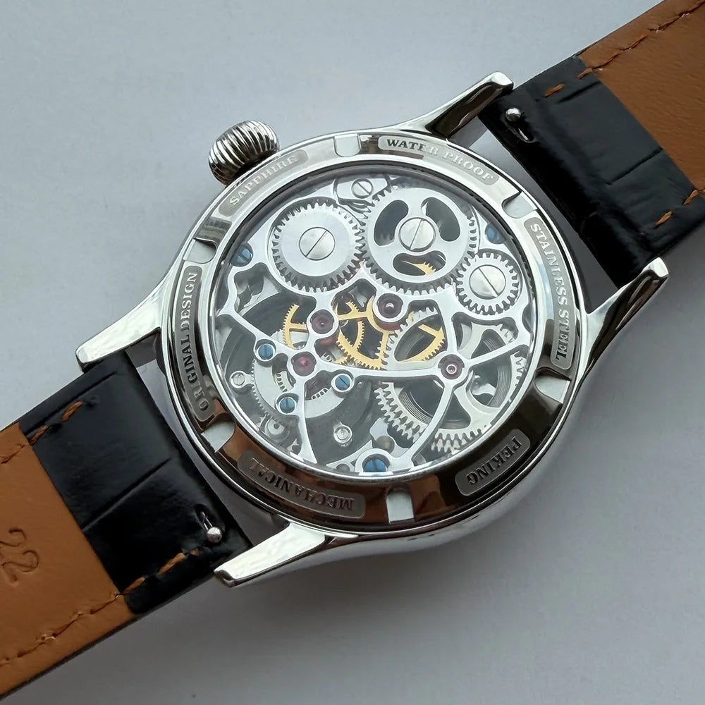 Mechanical watch with visible gears on a gray background
