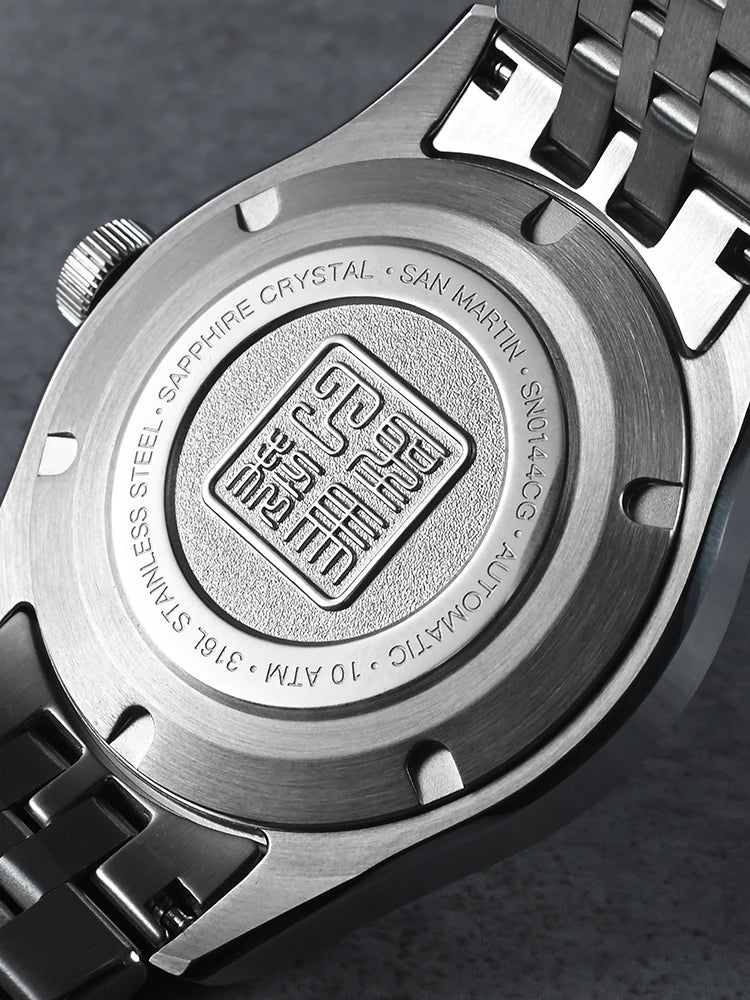 Close-up of a watch case with branding and technical details on a dark background