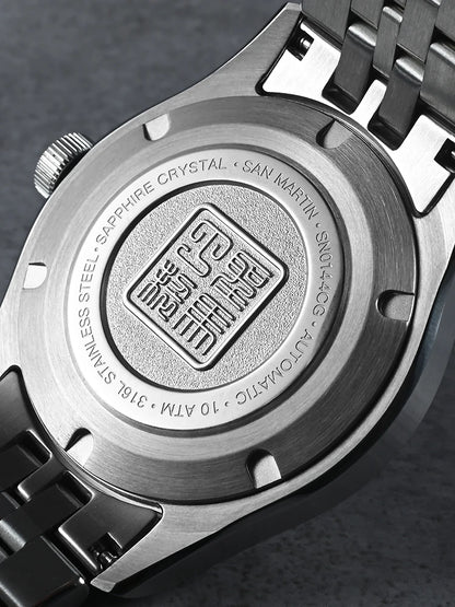Close-up of a watch case with branding and technical details on a dark background