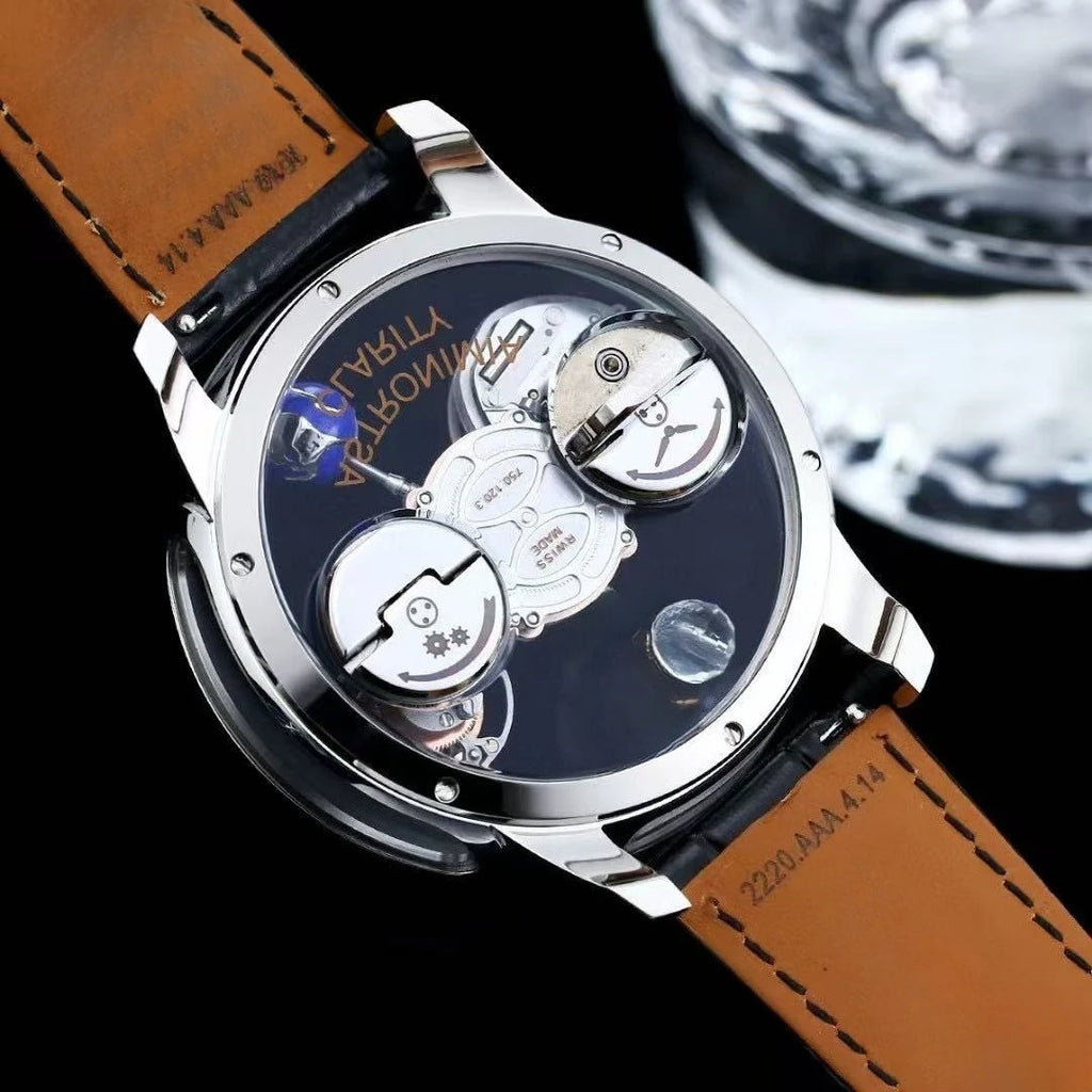 A luxury skeleton watch with a silver-tone case, brown leather strap, and a black dial showing the inner mechanical movement. The brand name 'VOSTRA' is visible on the watch dial.