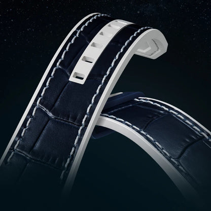 Close-up of a dark blue leather watch strap with white stitching on a black background