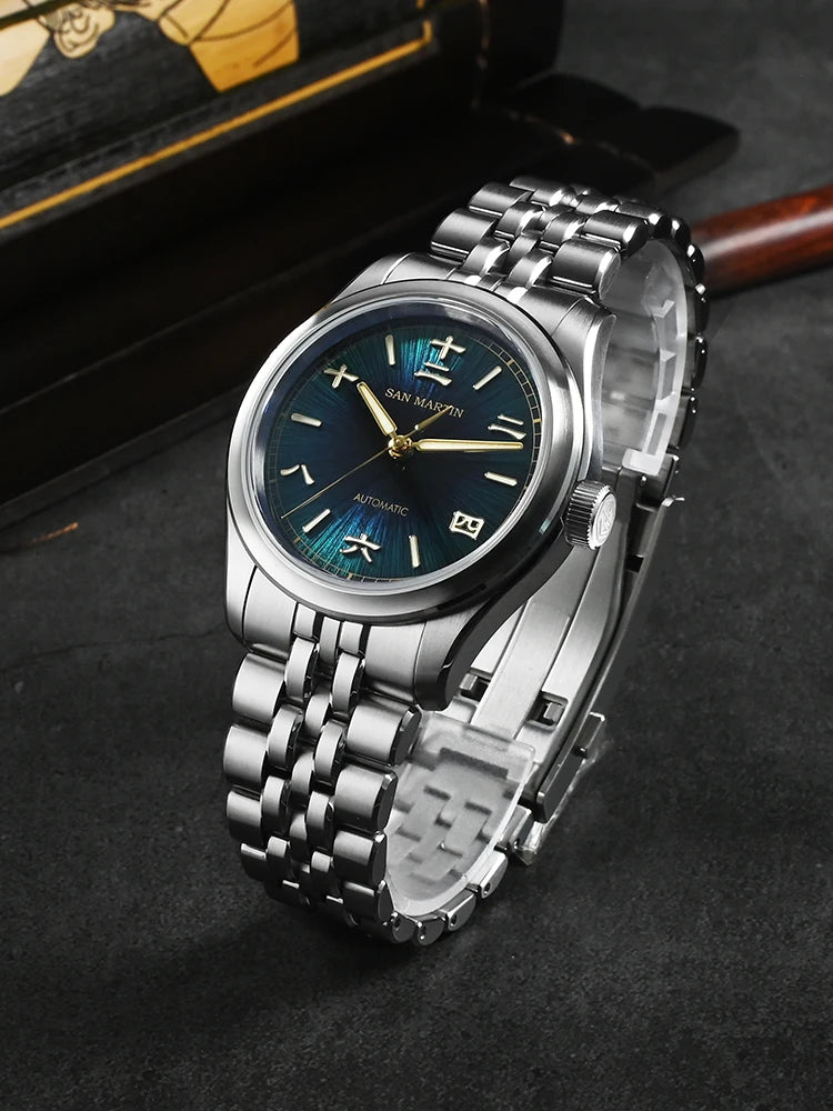 Silver wristwatch with blue dial on a dark surface
