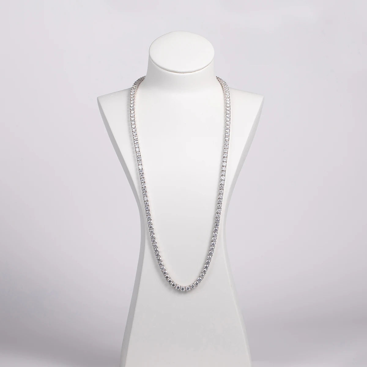 Silver necklace on a mannequin against a white background