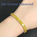 Gold bracelet with yellow gemstones on a wrist, labeled 'lab Grown Diamond'.