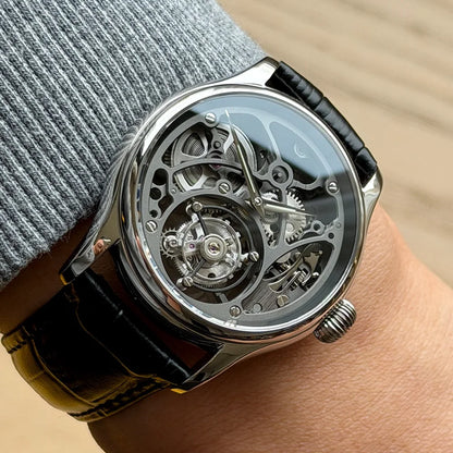 Close-up of a wrist wearing a detailed mechanical watch with a black strap.