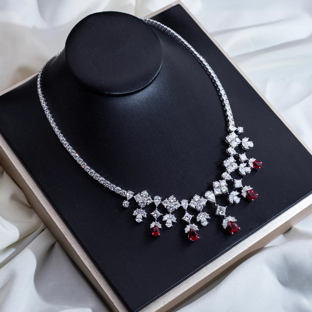 Elegant necklace with red gemstones on a black stand