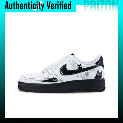 A white and black low-top sneaker with cartoon cat graphics, a black cat silhouette on the side, and white laces, shown against a white background with a teal border and an 'Authenticity Verified' banner at the top.