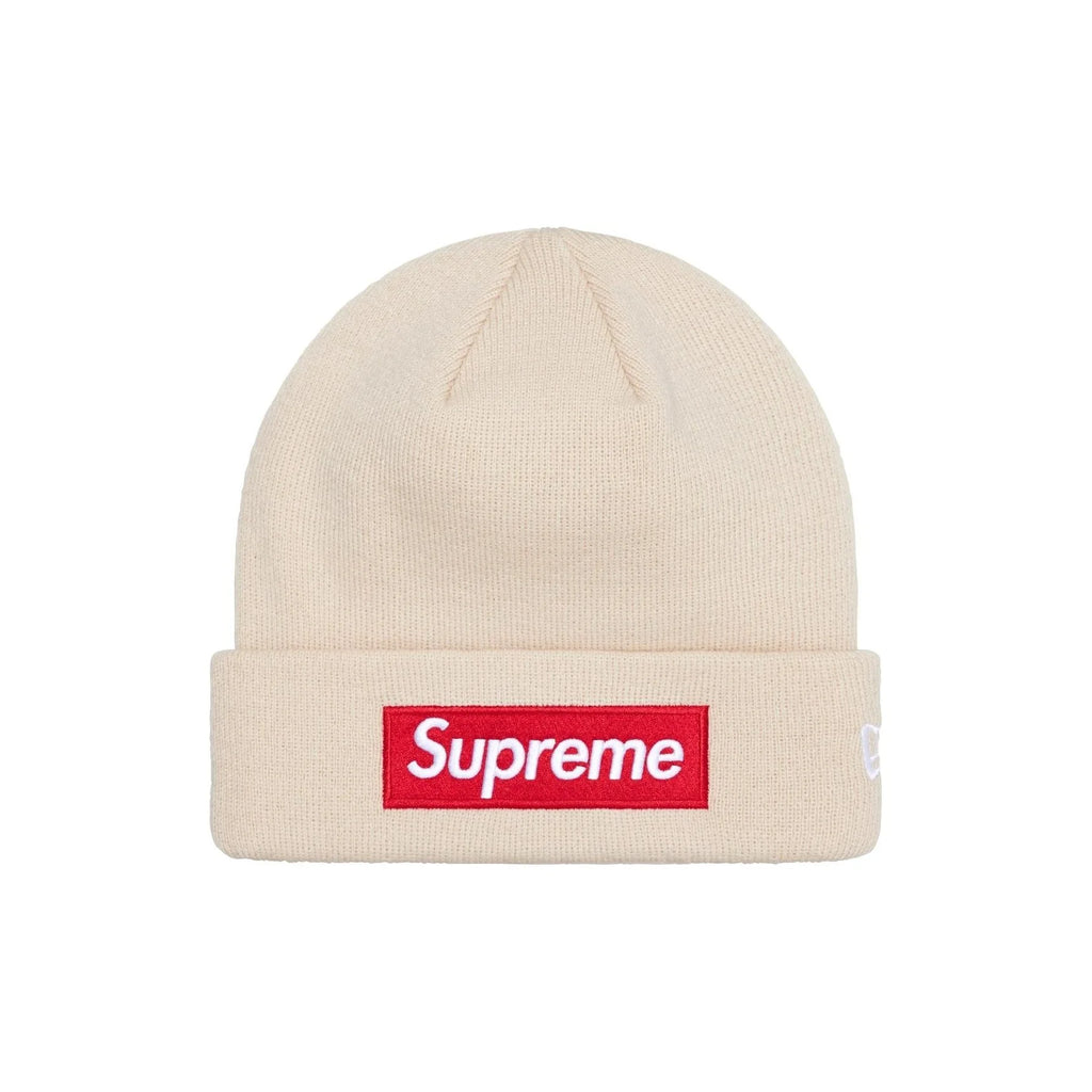 A beige ribbed knit beanie hat featuring a red rectangular box logo patch with white 'Supreme' text on the front cuff, shown against a plain white background.