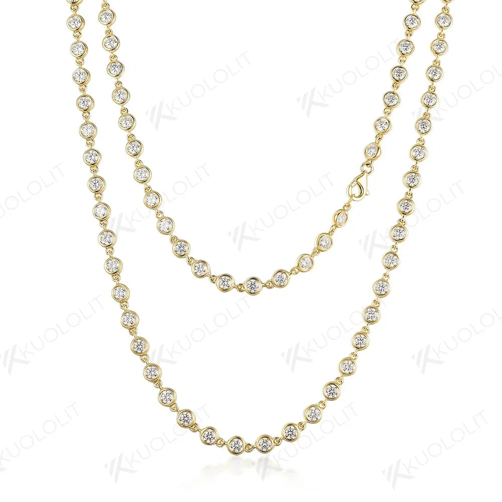 Gold necklace with clear stones on a white background