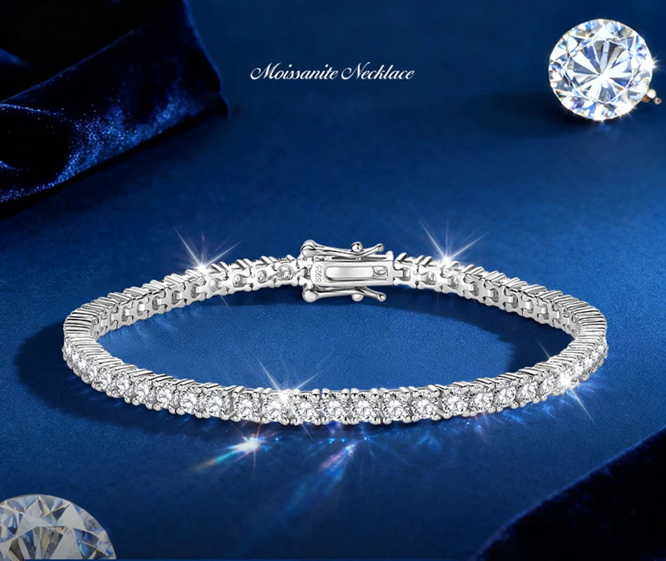 A silver tennis bracelet with round-cut clear stones, displayed on a dark blue velvet background with a moissanite necklace text overlay and a large moissanite gemstone in the top right corner.